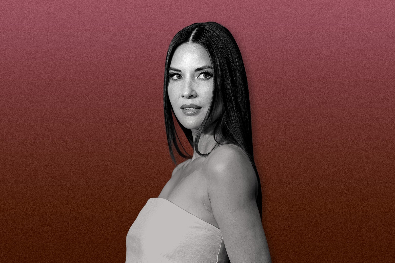 Olivia Munn in a white dress, against a maroon background.