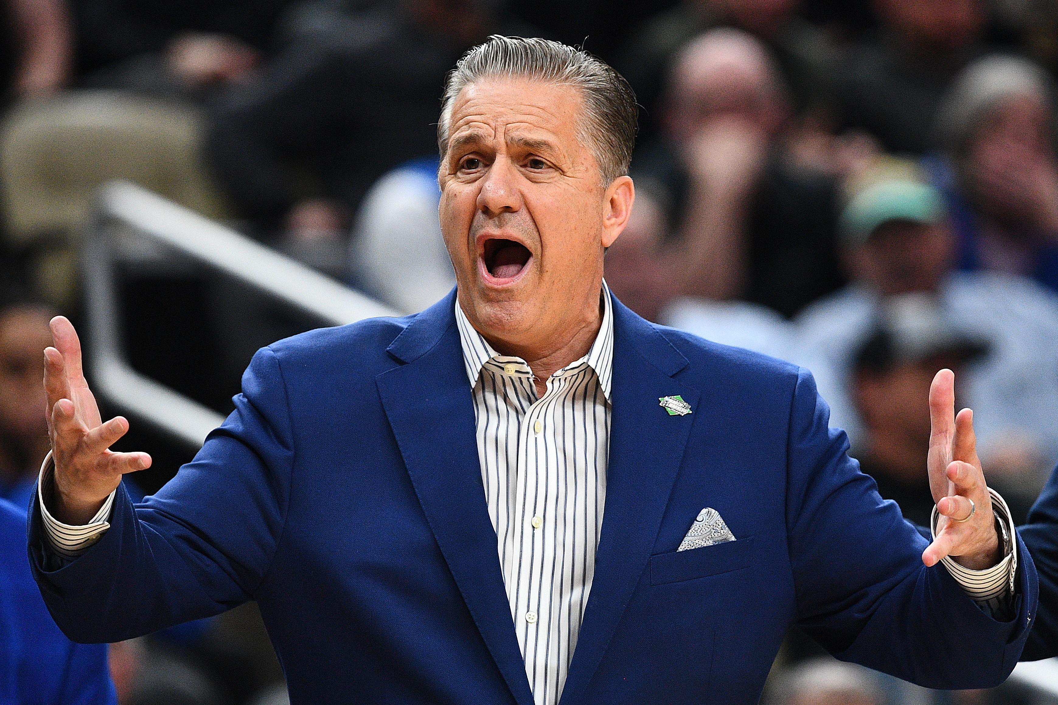 Calipari holds his hands out wide and yells.